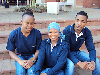 Three Unisa students smiling at the camera